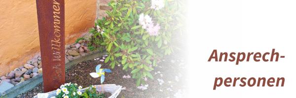 Garten mit Schild "Herzlich Willkommen"